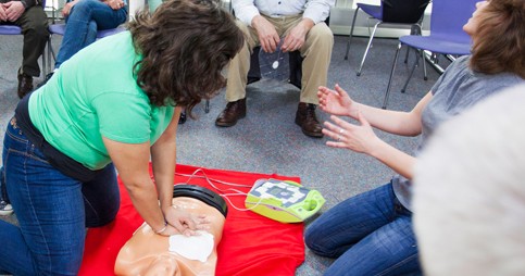 Woman Using AED on dummy