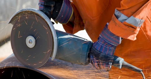 Worker Cutting with an abrasive wheel