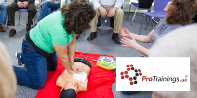 Woman administering CPR on the floor to dummy